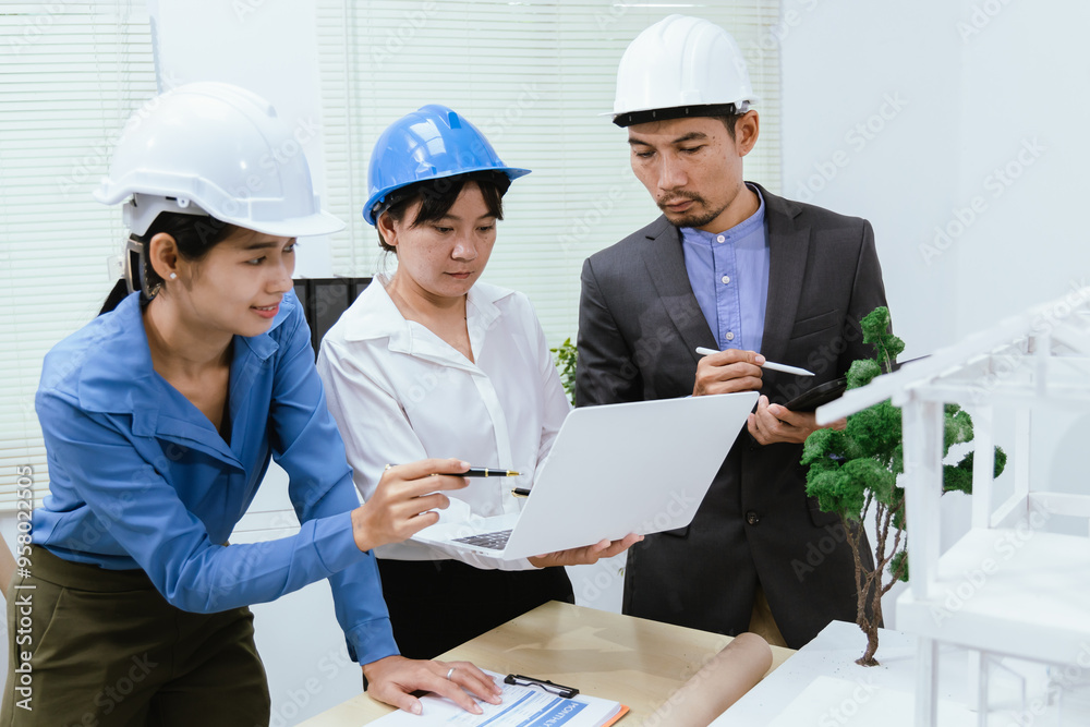 A team of architects and engineers work together in brainstorming sessions, discussing blueprints and construction plans for a real estate development. A team of architects and engineers work together in brainstorming sessions, discussing blueprints and construction plans for a real estate development.