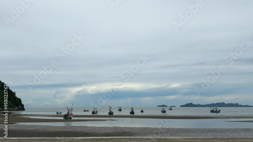 Landscape.Fishing boats are beautifully moored on the sandy beach during low tide.