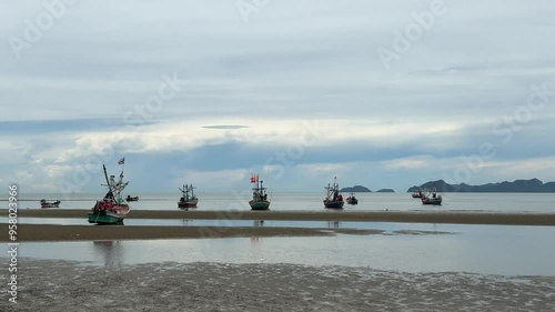 Fishing boats are beautifully lined up along the beach when the tide is low.