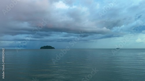 Orange-gray clouds and dark gray sea.