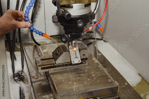 Production worker performing wire erosion photo