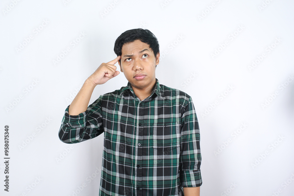 confused asian young man thoucing his head with finger showing try to remember gesture isolated confused asian young man thoucing his head with finger showing try to remember gesture isolated