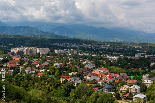 View of the built-up foothills of the Kazakh city of Almaty on a cloudy summer day