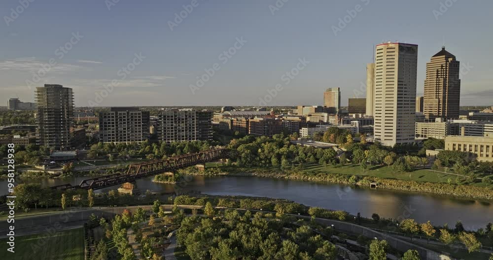 Columbus Ohio Aerial v58 low flyover Scioto greenway along the river bend capturing train bridge, arena district and downtown cityscape with sunset glows - Shot with Mavic 3 Pro Cine - Sept 21st 2023 Columbus Ohio Aerial v58 low flyover Scioto greenway along the river bend capturing train bridge, arena district and downtown cityscape with sunset glows - Shot with Mavic 3 Pro Cine - Sept 21st 2023