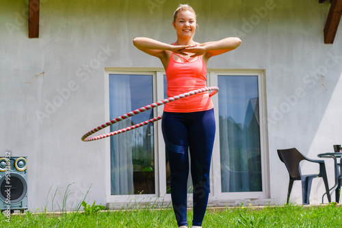 Young woman with hoola hoop outdoors photo