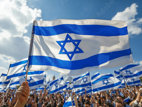 Person holding Israeli flag against a natural background