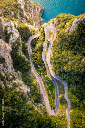 Garda Lake. Strada della Forra during a summer day and blue lake on the side.