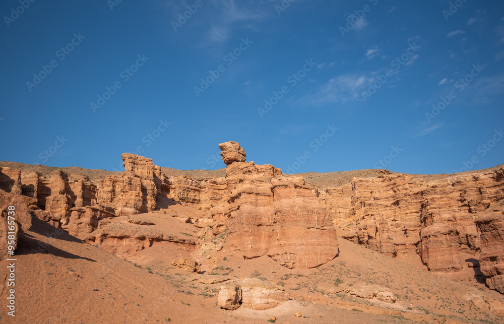 a striking range of massive red sandstone formations under a vast blue sky, hinting at a tranquil desert setting in the warm, gentle light of a late summer afternoon a striking range of massive red sandstone formations under a vast blue sky, hinting at a tranquil desert setting in the warm, gentle light of a late summer afternoon