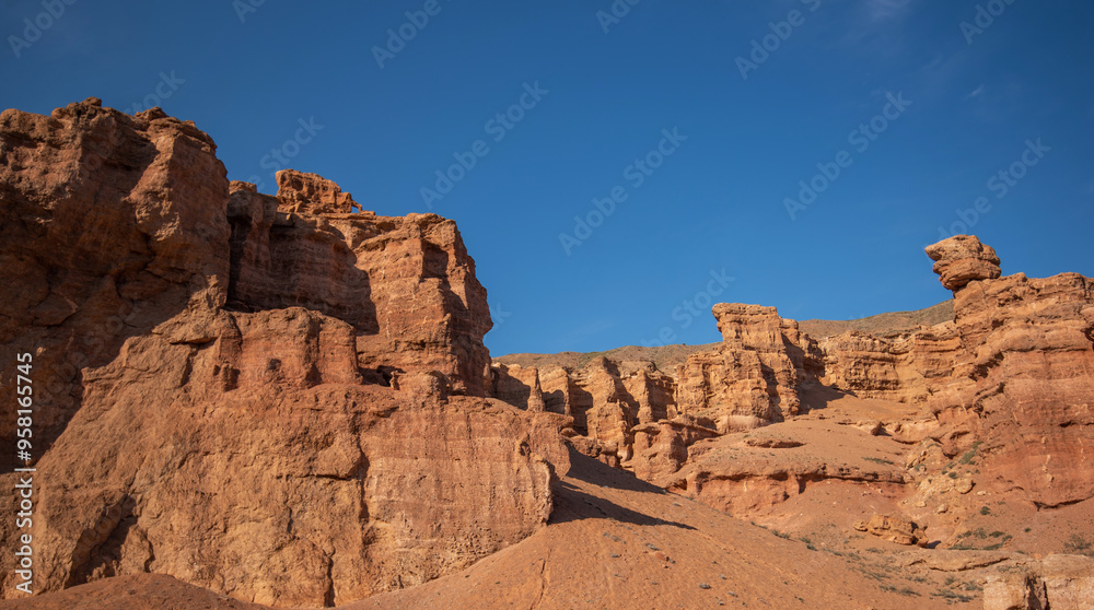 a striking range of massive red sandstone formations under a vast blue sky, hinting at a tranquil desert setting in the warm, gentle light of a late summer afternoon a striking range of massive red sandstone formations under a vast blue sky, hinting at a tranquil desert setting in the warm, gentle light of a late summer afternoon
