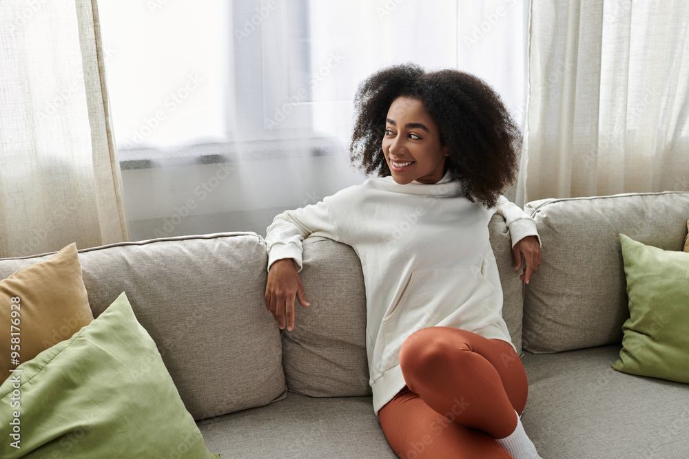 A young woman relaxes in her cozy attire, embracing comfort while enjoying her home environment. A young woman relaxes in her cozy attire, embracing comfort while enjoying her home environment.