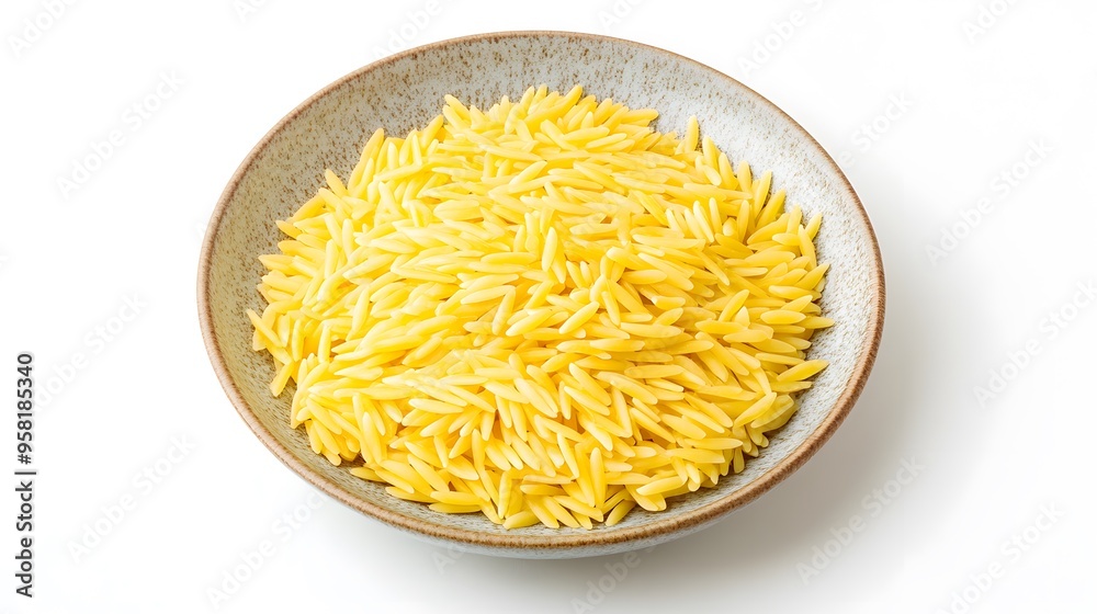 Bowl of raw orzo pasta on white background - top view close up Bowl of raw orzo pasta on white background - top view close up