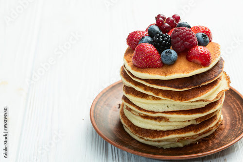 Stack of homemade american pancakes with berries . Top view