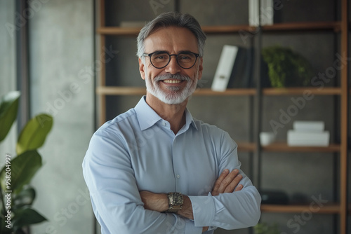 Mature smart businessman standing in modern office. Business people concept