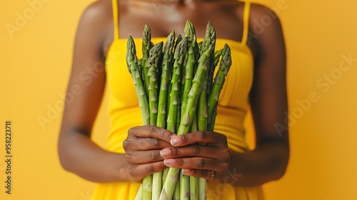 Woman hands holding a bunch of fresh asparagus.