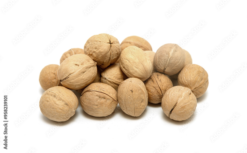 A pile of walnuts on a white background A pile of walnuts on a white background