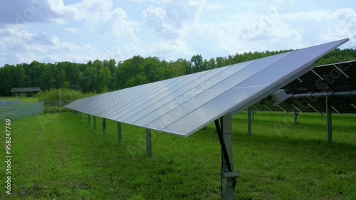 Solar panels with active tracker. PV panels tracking sun timelapse. Modern technology, renevable energy, solar panels moving towards sun, rural landscape	