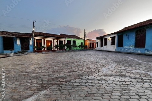 The AD 1732 last laid Plaza San Juan de Dios Square colonial buildings with red tiled-roofed houses, iron gilles, cobblestones. Camaguey-Cuba-365 photo