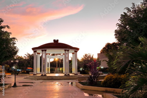 Parque Ricardo Cespedes Park at dusk with a roofed central pavilion in the form of a circular colonnade -monopteros or cyclostyle-. Niquero-Cuba-392 photo