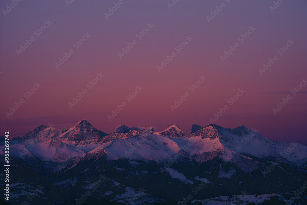 Snowy mountain peaks at sunset, glowing in soft violet tones Snowy mountain peaks at sunset, glowing in soft violet tones