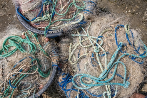 Old Fishing Nets Lies And Dries On The Shore On The Sand Of A Beach. With Fishing Buoys. Fishing Gear From Fishing Boats. Coast Of The Pond, éTang Canet-saint-nazaire) Traveling In Francee photo