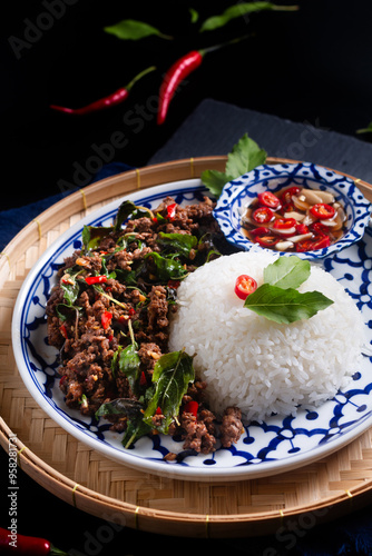 Food concept Thai authentic Khao Pad kra pao rice with Thai Holy Basil beef  Stir-Fry on black background with copy space