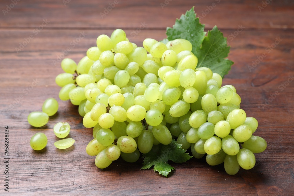 Delicious fresh ripe grapes on wooden table Delicious fresh ripe grapes on wooden table