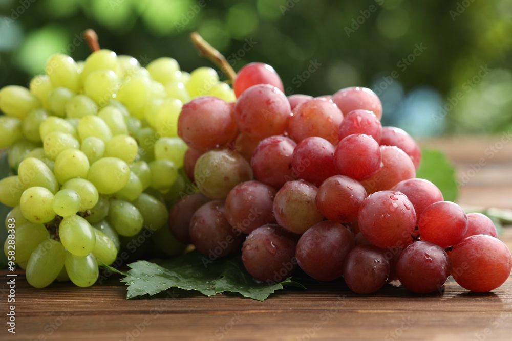 Fresh ripe grapes on wooden table, closeup Fresh ripe grapes on wooden table, closeup