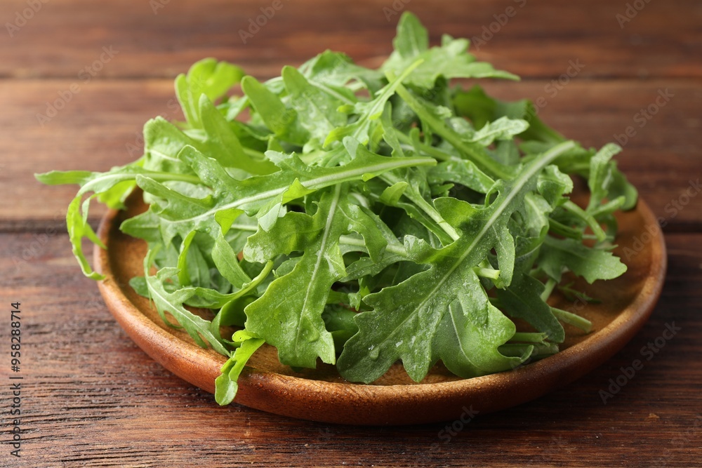 Fresh green arugula leaves on wooden table, closeup Fresh green arugula leaves on wooden table, closeup