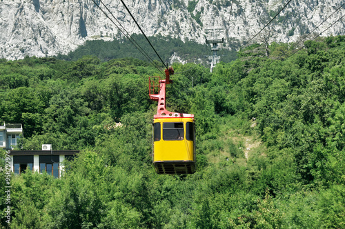 Cable car with yellow Funicular cabin, cable transportation system, mountains trip, tourism industry