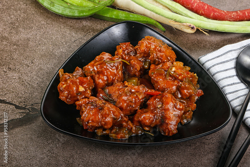 Manchurian chicken with sauce and spices photo