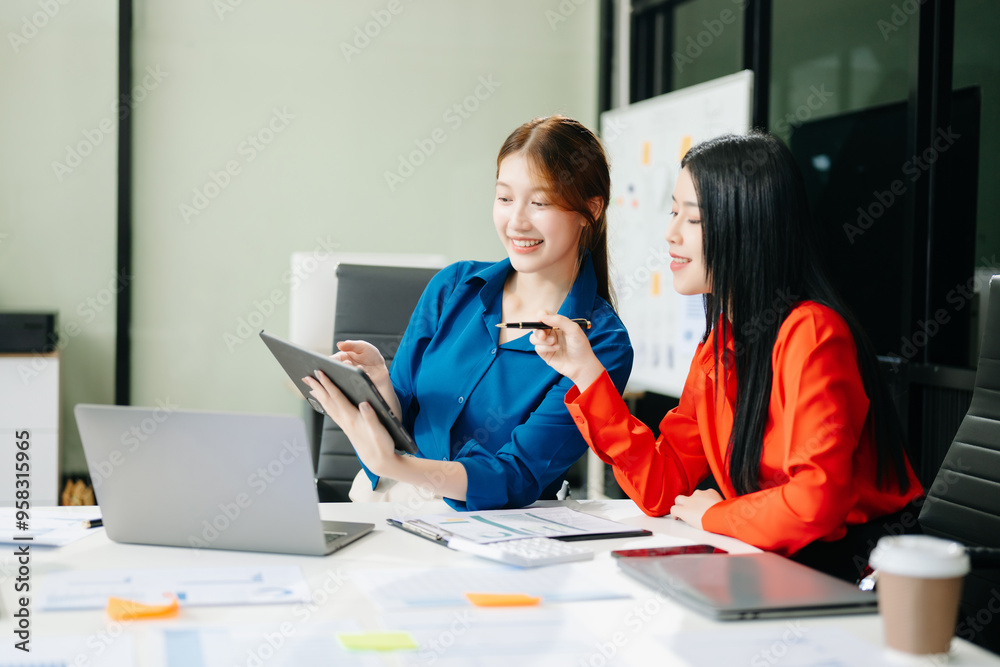 Asian business colleague business presents and explains and using laptop and tablet. Teamwork, financial Asian business colleague business presents and explains and using laptop and tablet. Teamwork, financial