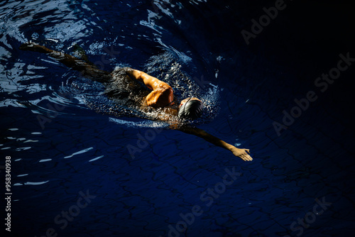 Professional female swimmer swimming the front crawl stroke