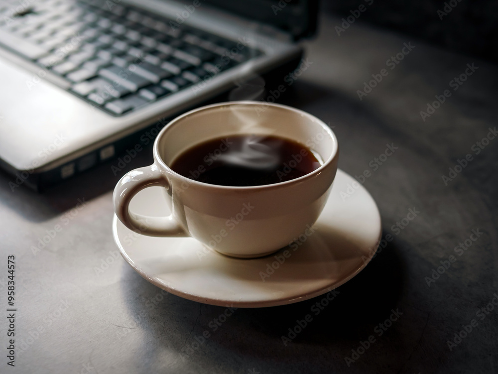 Relax during business work concept, americano coffee cup and black coffee cup aromatic and laptop computer in morning Relax during business work concept, americano coffee cup and black coffee cup aromatic and laptop computer in morning