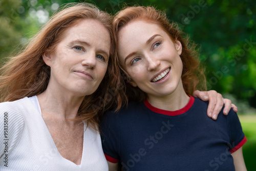 A Heartfelt Moment Shared Between a Mother and Daughter in a Lush Green Park on a Sunny Day