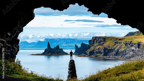 A breathtaking view from a cave, showcasing rugged cliffs and serene waters, inviting adventure and tranquility in nature.
