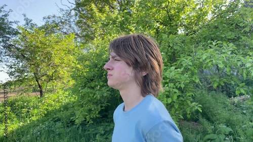 Thinkful a boy with brown hair and a blue shirt, looking at the camera, thoughtful look photo