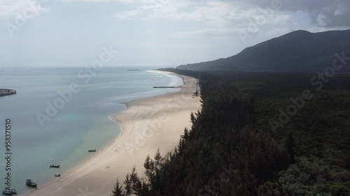 Beautiful sandy coastline and jungle at Riyue Bay near Sanya photo