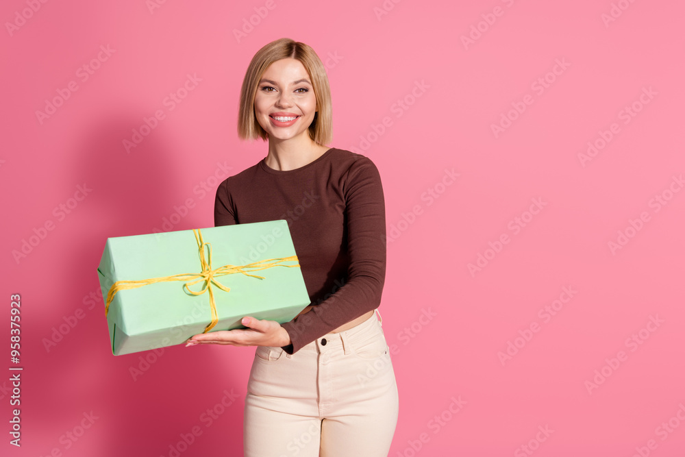 Photo of lovely pretty adorable girl wear trendy brown clothes hold gift empty space isolated on pink color background Photo of lovely pretty adorable girl wear trendy brown clothes hold gift empty space isolated on pink color background
