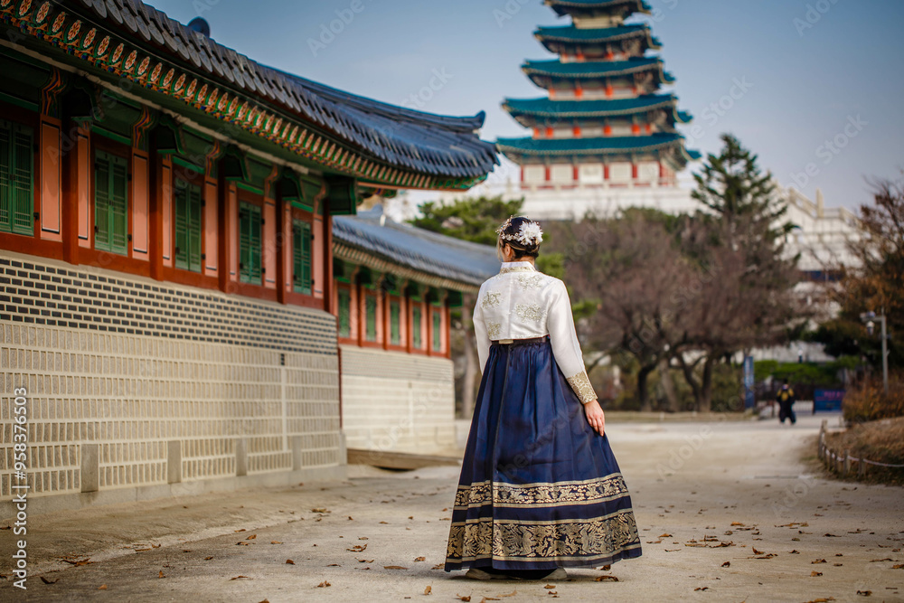 Tourists in national clothes walk in Gyeongbokgung Palace. Hanbok dress. South Korea