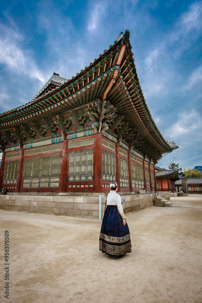 Tourists in national clothes walk in Gyeongbokgung Palace. Hanbok dress. South Korea