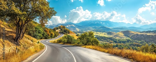 Winding road through mountain landscape on a sunny day