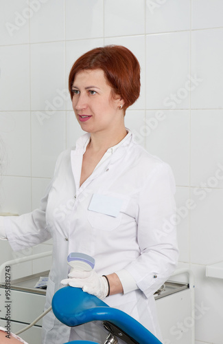 Gynecologist ready to do transvaginal ultrasound with wand and exam a woman