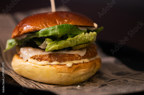 Chiken cheese burger with bacon on black background photo