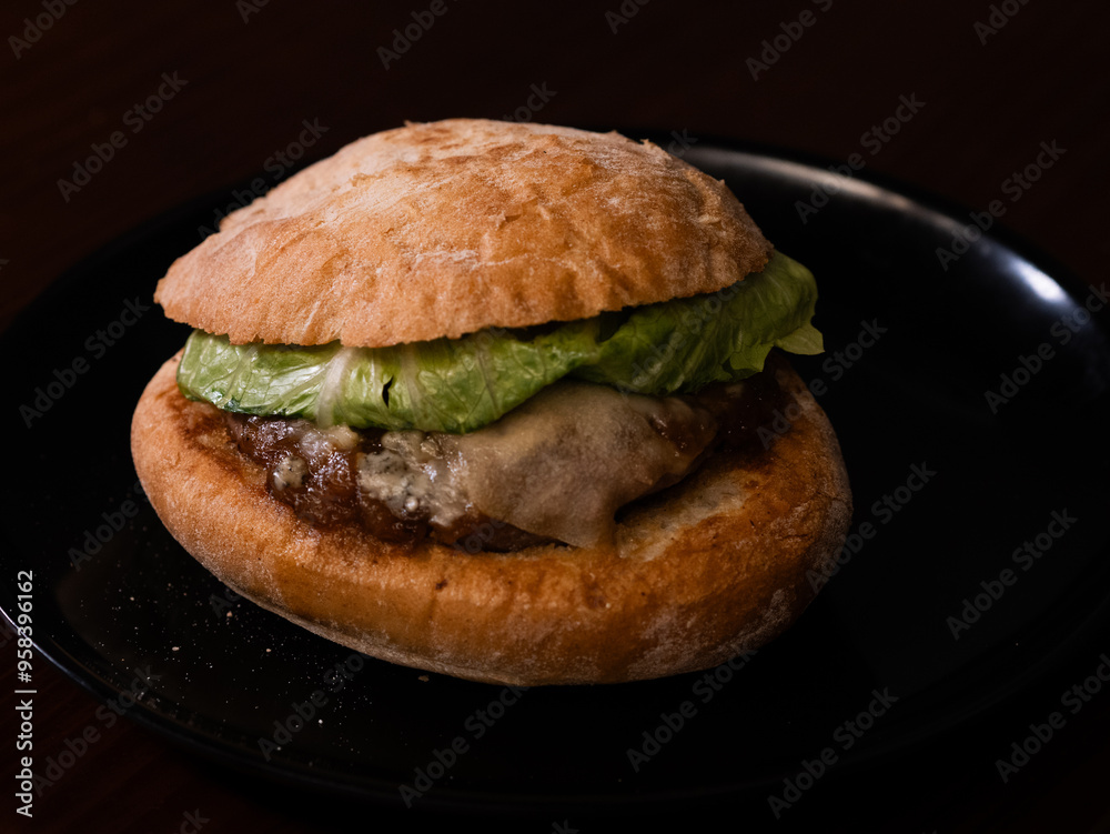 Cheese burger with bacon on black background Cheese burger with bacon on black background