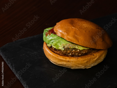 Cheese burger with bacon on black background photo