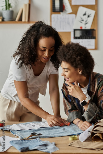 A couple joyfully redesigns their clothing in a vibrant workspace. photo