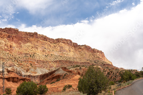 A cloudy and sunny view of red rocks at Capitol Reef National Park in Utah.