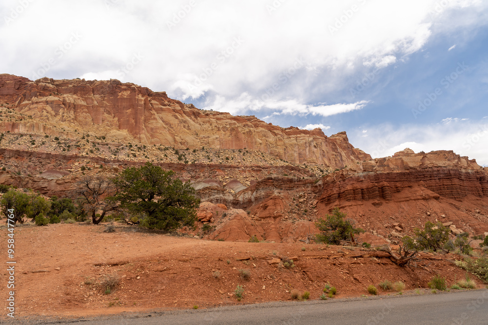 A cloudy and sunny view of red rocks at Capitol Reef National Park in Utah.