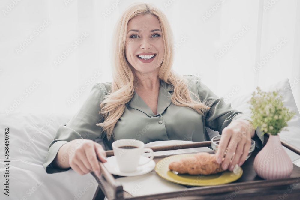 Photo of pretty young woman croissant coffee tray bed silky pajama white interior bedroom apartment indoors Photo of pretty young woman croissant coffee tray bed silky pajama white interior bedroom apartment indoors