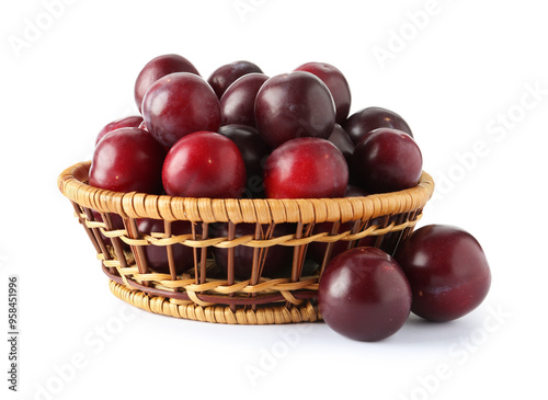 Fresh ripe plums in wicker bowl isolated on white